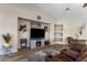 Comfortable living room featuring wood-look floors, decorative fireplace, and ample space for relaxation at 1415 N Frederick Ln, Casa Grande, AZ 85122