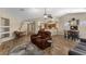 Open-concept living room with hardwood floors and comfortable seating, flowing into dining and kitchen areas at 1415 N Frederick Ln, Casa Grande, AZ 85122