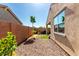 Cozy backyard with desert landscaping, brick wall, and a covered patio at 14233 W Georgia Dr, Surprise, AZ 85379