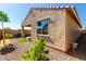 Well-maintained backyard with desert landscaping, covered patio, and privacy fencing at 14233 W Georgia Dr, Surprise, AZ 85379