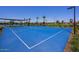 Bright blue community basketball court with lush green landscaping surrounding the exterior at 14233 W Georgia Dr, Surprise, AZ 85379