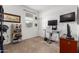 This bedroom features a dedicated computer work area, a tv and nice window at 14233 W Georgia Dr, Surprise, AZ 85379