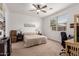 Neutral bedroom with a ceiling fan, window, and carpet; ready for relaxation and personalization at 14233 W Georgia Dr, Surprise, AZ 85379