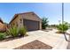 This single-level home features a two-car garage with desert landscaping and easy street access at 14233 W Georgia Dr, Surprise, AZ 85379