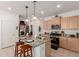 Well-appointed kitchen featuring granite countertops, pendant lighting, and a functional island with bar seating at 14233 W Georgia Dr, Surprise, AZ 85379