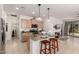Modern kitchen featuring an island with barstool seating, pendant lighting, and stainless steel appliances at 14233 W Georgia Dr, Surprise, AZ 85379