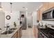 Well-lit kitchen features granite counters, stainless steel appliances, tile floors, and an island with a dual sink at 14233 W Georgia Dr, Surprise, AZ 85379