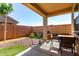 Charming covered patio featuring a dining set and desert landscaping at 14233 W Georgia Dr, Surprise, AZ 85379