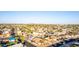 Wide aerial shot capturing a suburban neighborhood featuring well-maintained homes, mature trees, and clear blue skies at 14821 N 62Nd Ave, Glendale, AZ 85306