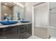 Stylish bathroom with dual vessel sinks, granite countertops, and dark wood cabinetry at 14821 N 62Nd Ave, Glendale, AZ 85306
