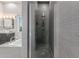 This bathroom features gray tiling, a walk-in shower, a soaking tub, and a vessel sink with granite vanity at 14821 N 62Nd Ave, Glendale, AZ 85306