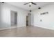 This bedroom features neutral walls, hardwood floors, wiring for a tv on the wall, and open doors to the bathroom at 14821 N 62Nd Ave, Glendale, AZ 85306