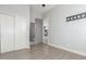 This spacious bedroom has hardwood floors, a ceiling fan, closet, and an open doorway to the bathroom at 14821 N 62Nd Ave, Glendale, AZ 85306