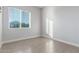 Bright bedroom features wood-style floors and a window for natural light and ventilation at 14821 N 62Nd Ave, Glendale, AZ 85306