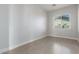Well-lit bedroom with wood-style flooring and a bright window for natural light at 14821 N 62Nd Ave, Glendale, AZ 85306