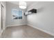 Cozy bedroom featuring a modern light fixture, floating shelves, and wood-look floors at 14821 N 62Nd Ave, Glendale, AZ 85306