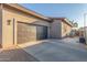 Wide driveway with a garage, neutral stucco, and lots of parking space at 14821 N 62Nd Ave, Glendale, AZ 85306