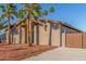Charming single-story home showcasing desert landscaping, a red tile roof, and a private gated entrance at 14821 N 62Nd Ave, Glendale, AZ 85306