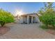 Charming single-story home showcasing desert landscaping, a covered patio, and a welcoming brick driveway at 14821 N 62Nd Ave, Glendale, AZ 85306