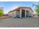 Back exterior view showing a covered patio with neutral stucco and brick driveway at 14821 N 62Nd Ave, Glendale, AZ 85306