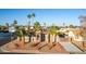 Charming home with desert landscaping, mature palm trees, and a welcoming entrance at 14821 N 62Nd Ave, Glendale, AZ 85306