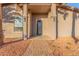 Close-up of front porch featuring a sleek black security door and xeriscape landscaping at 14821 N 62Nd Ave, Glendale, AZ 85306