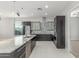 Bright kitchen features granite countertops, stainless steel appliances, dark cabinetry, and an island with a sink at 14821 N 62Nd Ave, Glendale, AZ 85306