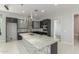 Bright kitchen features granite countertops, stainless steel appliances, dark cabinetry, and an island with a sink at 14821 N 62Nd Ave, Glendale, AZ 85306