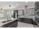 Bright kitchen features granite countertops, stainless steel appliances, dark cabinetry, and an island with a sink at 14821 N 62Nd Ave, Glendale, AZ 85306