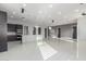 Bright kitchen with tile flooring, modern lighting, a large island, and dark cabinets at 14821 N 62Nd Ave, Glendale, AZ 85306