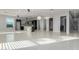Open living space with tile flooring, modern lighting, and a view of the kitchen at 14821 N 62Nd Ave, Glendale, AZ 85306