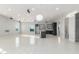 Open floor plan with tile flooring, modern lighting and a large island with a sink at 14821 N 62Nd Ave, Glendale, AZ 85306