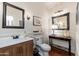 Charming powder room with wooden vanity, decorative mirrors, and modern fixtures at 15240 N Clubgate Dr # 160, Scottsdale, AZ 85254