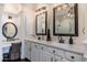 Bright bathroom featuring double sinks, granite countertops, and decorative mirrors and lighting fixtures at 15240 N Clubgate Dr # 160, Scottsdale, AZ 85254