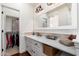 Bathroom with stylish mirror, countertop, and convenient access to the closet at 15240 N Clubgate Dr # 160, Scottsdale, AZ 85254