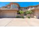 Contemporary home featuring a two-car garage and small palm trees at 15240 N Clubgate Dr # 160, Scottsdale, AZ 85254