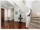 Inviting foyer with hardwood floors, a curved staircase, and a decorative table with an elegant display at 15240 N Clubgate Dr # 160, Scottsdale, AZ 85254