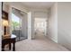 Cozy hallway featuring neutral carpet, access to the balcony, and a glimpse into the Primary bedroom at 15240 N Clubgate Dr # 160, Scottsdale, AZ 85254