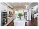 Bright kitchen features white cabinetry, stainless appliances, brick backsplash and large island at 15240 N Clubgate Dr # 160, Scottsdale, AZ 85254