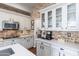 Bright kitchen features white cabinets, brick wall, and stainless steel appliances at 15240 N Clubgate Dr # 160, Scottsdale, AZ 85254