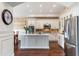 Stylish kitchen features white cabinets, stainless appliances, brick backsplash and large island at 15240 N Clubgate Dr # 160, Scottsdale, AZ 85254
