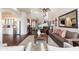 Open concept living room with view to staircase, kitchen and fireplace at 15240 N Clubgate Dr # 160, Scottsdale, AZ 85254