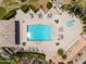 Aerial view of a pool and spa with patio furniture and mature landscaping, surrounded by manicured grounds at 15240 N Clubgate Dr # 160, Scottsdale, AZ 85254