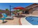 Inviting backyard oasis featuring a sparkling pool, comfortable seating, lush landscaping, and a serene atmosphere at 16219 W Yucatan Dr, Surprise, AZ 85379
