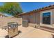 Backyard with stainless steel barbecue grill, air conditioning unit, and an outdoor window at 16219 W Yucatan Dr, Surprise, AZ 85379
