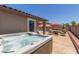 Serene backyard showcasing a hot tub, patio seating, mature landscaping, and a sense of privacy at 16219 W Yucatan Dr, Surprise, AZ 85379