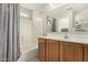 Bright bathroom featuring shower and tub, vanity and oak cabinets at 16219 W Yucatan Dr, Surprise, AZ 85379