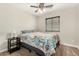 Bedroom showcasing ceiling fan, lamp and window with blinds for added privacy at 16219 W Yucatan Dr, Surprise, AZ 85379
