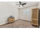 Bedroom featuring a ceiling fan, window with blinds, and cabinet at 16219 W Yucatan Dr, Surprise, AZ 85379