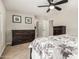 Bedroom showcasing dresser, ensuite bathroom and ceiling fan at 16219 W Yucatan Dr, Surprise, AZ 85379